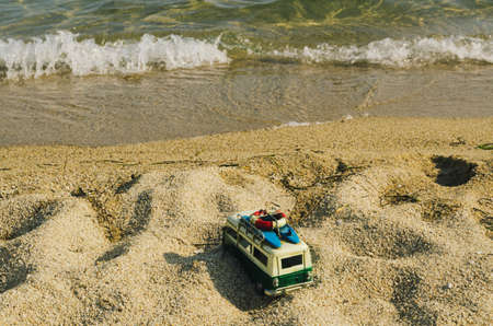 An old camper van parked n a sandy beach. Relaxed summer holidays in nature concept.の写真素材