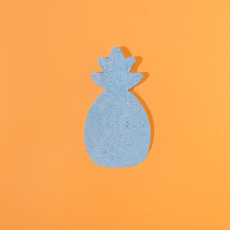A pastel blue ananas on an orange background. Minimal summer contrast creative concept. Surreal retro design.の写真素材