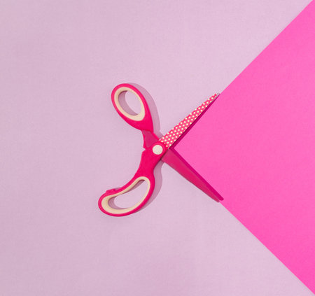 Wide open fuchsia scissors on a lilac and fuchsia background. Minimal modern office work concept. Colorful school and education artistic concept.の写真素材