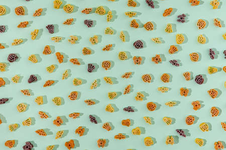 A bright pattern made of pasta in the shape of Halloween symbols on pastel green background. Halloween food or meal creative concept.の写真素材