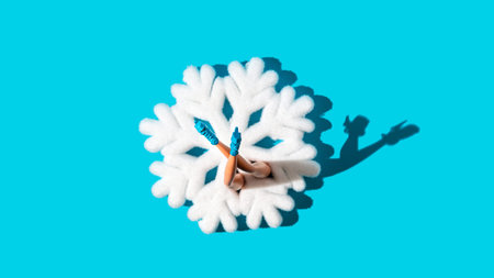 Women's legs in blue shoes emerging from a big snowflake on pastel blue background. Festive...