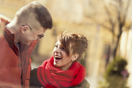 Beautiful young couple standing next to a shop windowの写真素材
