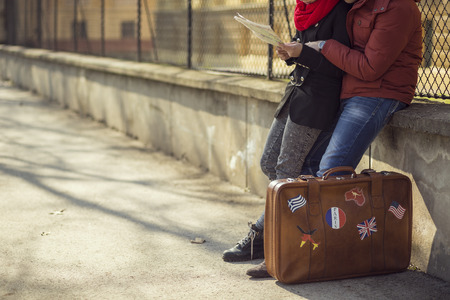 Young couple sitting and planning the tripの写真素材