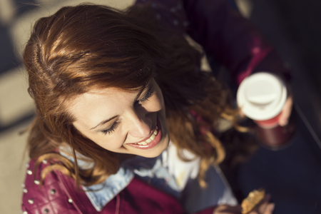 Young business woman enjoying coffee while surfing the Internet, top viewの写真素材