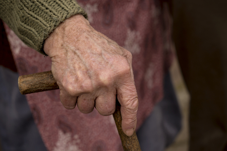 Elderly woman holding stickの写真素材