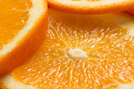 Close up of juicy orange fruit cross sections. Selective focus