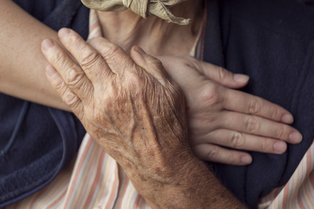Old and young person holding hands. Elderly care and respect, selective focusの写真素材