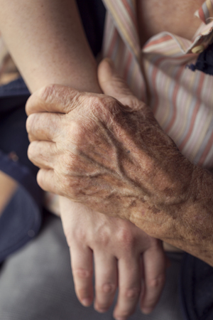 Old and young person holding hands. Elderly care and respect, selective focusの写真素材