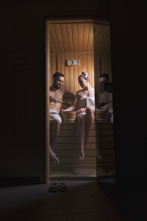 Young couple enjoying the sauna session together and relaxingの写真素材