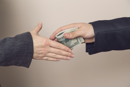 Detail of two business people sealing the deal with bribe money. Selective focusの写真素材