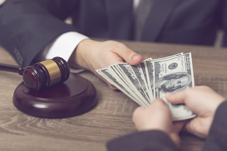 Detail of a corrupted judge taking a bribe money. Selective focusの写真素材