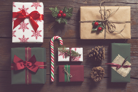 Top view of nicely wrapped Christmas presents laid on the wooden tableの写真素材