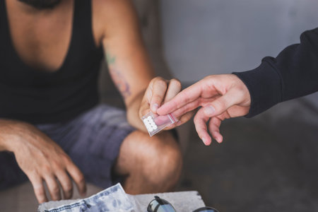 Drug dealer selling ecstasy pills to a drug addict