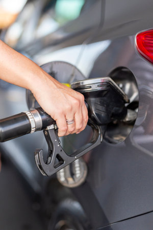 Car refueling at a petrol station; car tank refilling at a gas station