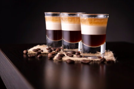 Three shots of B-52 cocktail placed on a bar counter