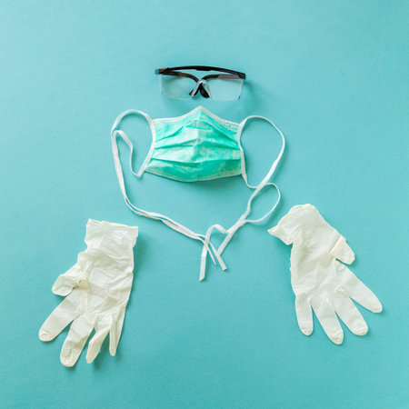 Medical face protection mask, protective gloves and lab glasses as part of prevention gear against...