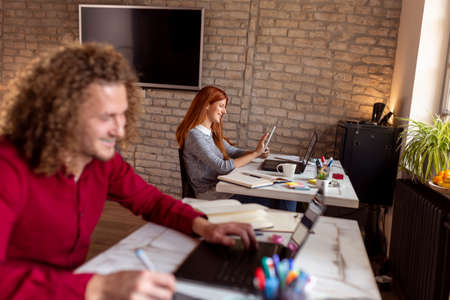 Business colleagues working in a modern office; freelancers working in a coworking spaceの写真素材
