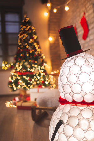 Detail of home Christmas decorations with nicely decorated Christmas tree and presents all around it
