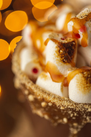 Detail of eggnog cocktail served in a glass with cinnamon powder rim, decorated with grated nutmeg,...