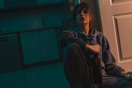 Junike shooting up with heroin; female drug addict injecting herself with heroin dose intravenously; drug addiction and substance abuse concept. Focus on the tourniquetの写真素材