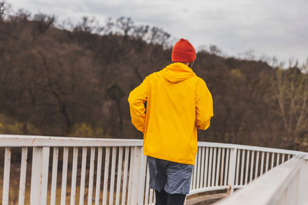 Low angle view of an active man in sportswear taking a break while going for a morning runの写真素材