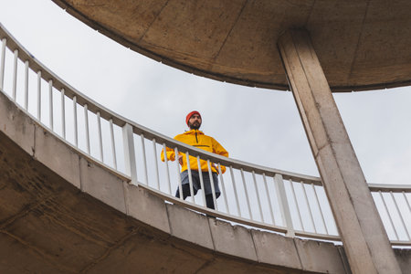 Low angle view of an active man in sportswear taking a break while going for a morning runの写真素材