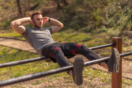 Handsome active young man taking a break while having an outdoor training session in a street...