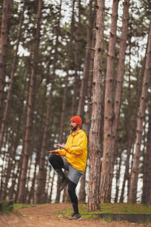 Detail of a man working out outdoors on a cloudy autumn day, walking down the jogging trackの写真素材