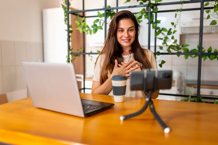 Female vlogger recording video for her vlog in inprovised home studio