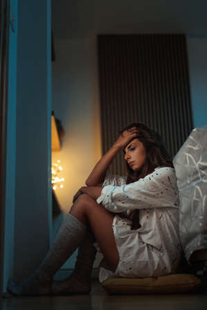 Female freelancer working late, using laptop computer in bed at nightの写真素材