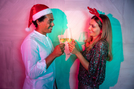 Couple in love having fun singing, dancing and drinking champagne at New Year party midnight countdownの写真素材
