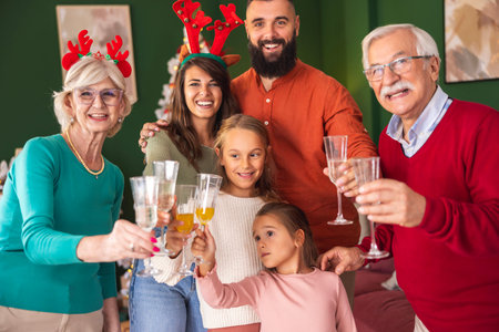 Beautiful happy multi-generation family celebrating Christmas at home, having fun making a toast...