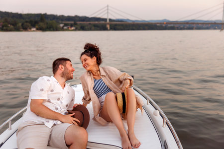 Beauitful young couple in love relaxing and having fun sailing on a boat while on summer vacationの写真素材