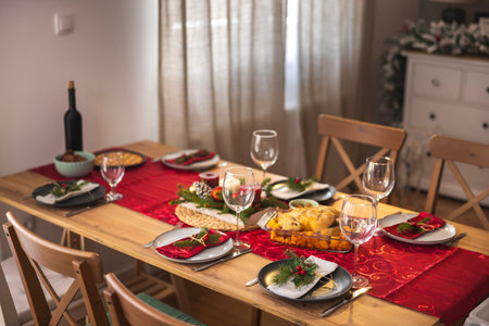 High angle view of beautiful Christmas dinner table setting at cozy home ready for holiday family gatheringの写真素材