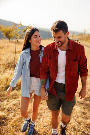 Beautiful couple in love having fun hiking in nature, enjoying sunny summer day together outdoors