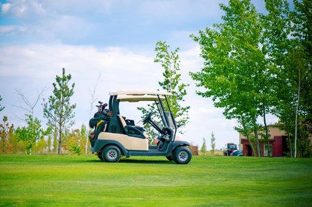 A golf car on a green golf fieldの写真素材