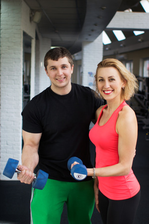 Cheerful couple with fitness dumbbellsの写真素材
