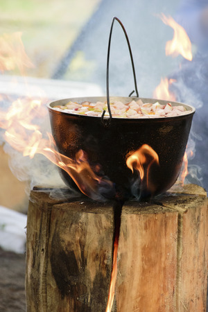 Cooking in cauldron on Finnish candleの写真素材