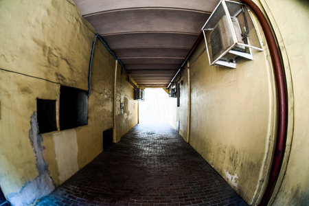 Light at the end of the tunnel. Old dirty city arch tunnel. Fisheye effectの写真素材