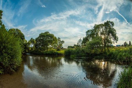 Calm river in the summer. Place for fishing in the river.の写真素材