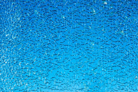 Texture of broken glass on a blue backgroundの写真素材