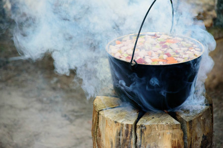 Cooking in cauldron on Finnish, Swedish log stove