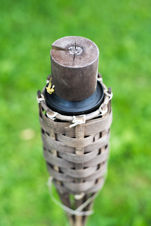 Close-up of traditional bamboo torches oil lamp on nature background.の写真素材