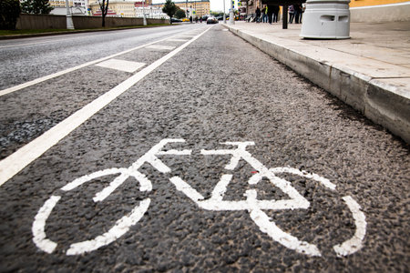 Separate bicycle lane for riding bicycles. White painted bike on asphalt. Ride ecological green urban transportの写真素材