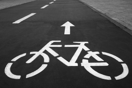 Separate bicycle lane for riding bicycles. White painted bike on asphalt. Ride ecological green urban transportの写真素材