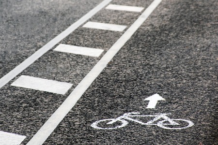 Separate bicycle lane for riding bicycles. White painted bike on asphalt. Ride ecological green urban transportの写真素材