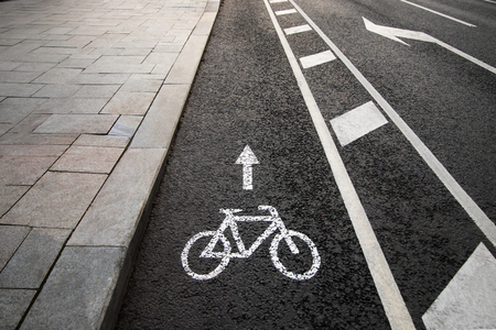 Separate bicycle lane for riding bicycles. White painted bike on asphalt. Ride ecological green urban transportの写真素材