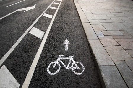 Separate bicycle lane for riding bicycles. White painted bike on asphalt. Ride ecological green urban transportの写真素材