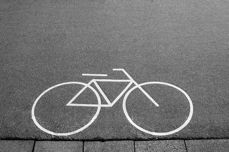Separate bicycle lane for riding bicycles. White painted bike on asphalt. Ride ecological green urban transportの写真素材