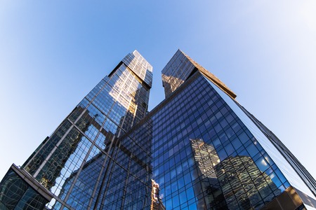 Perspective low angle view of modern glass skyscrapers facadesの写真素材